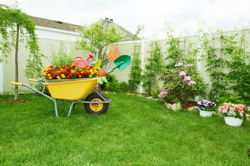 Workers carrying out safe landscaping tasks with protective equipment
